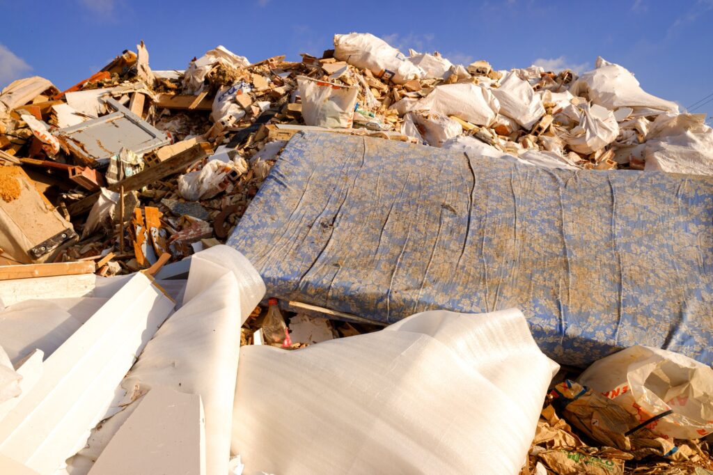 Garbage and debris thrown in an illegal landfill in the orchard on the outskirts of the city.